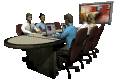 GIF image of a meeting at a table with a large screen